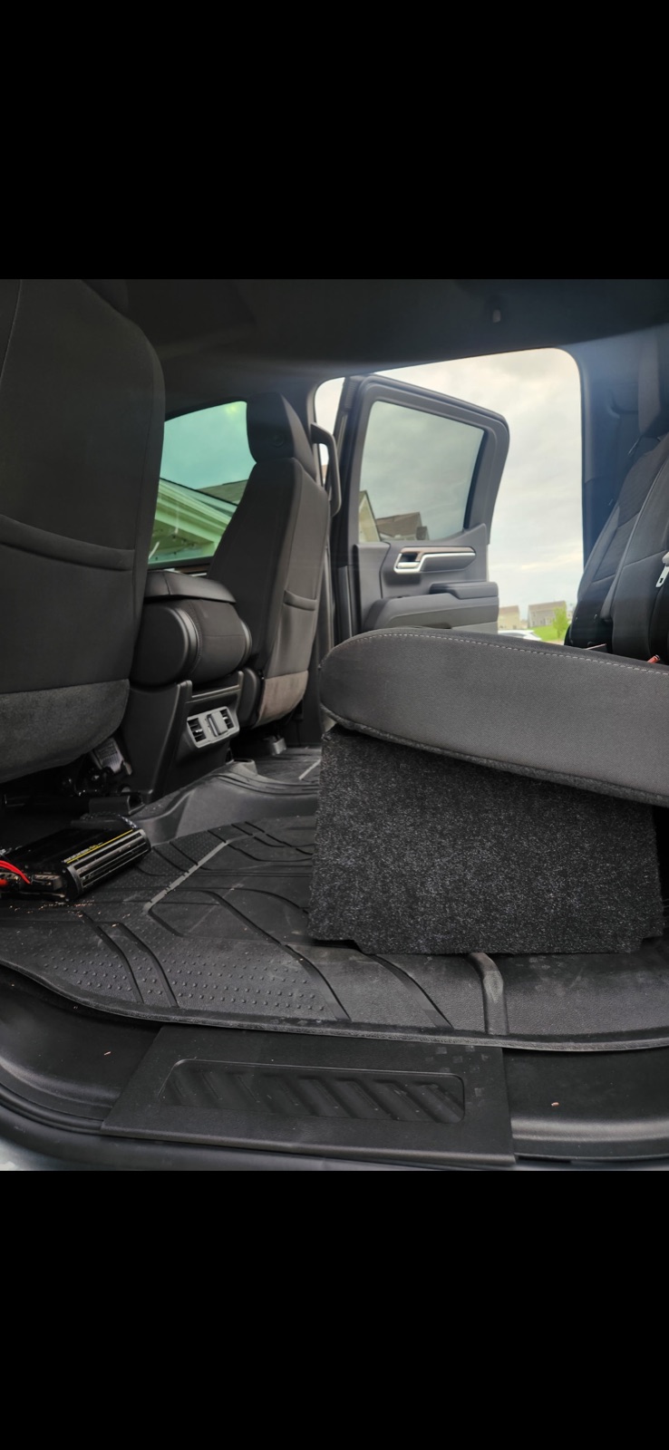 Under-seat subwoofer and amplifier installed in a truck
